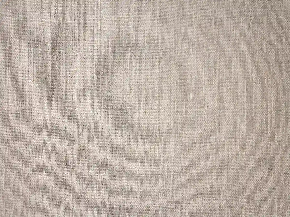 Close-up of woven linen fabric showing its loose, open weave