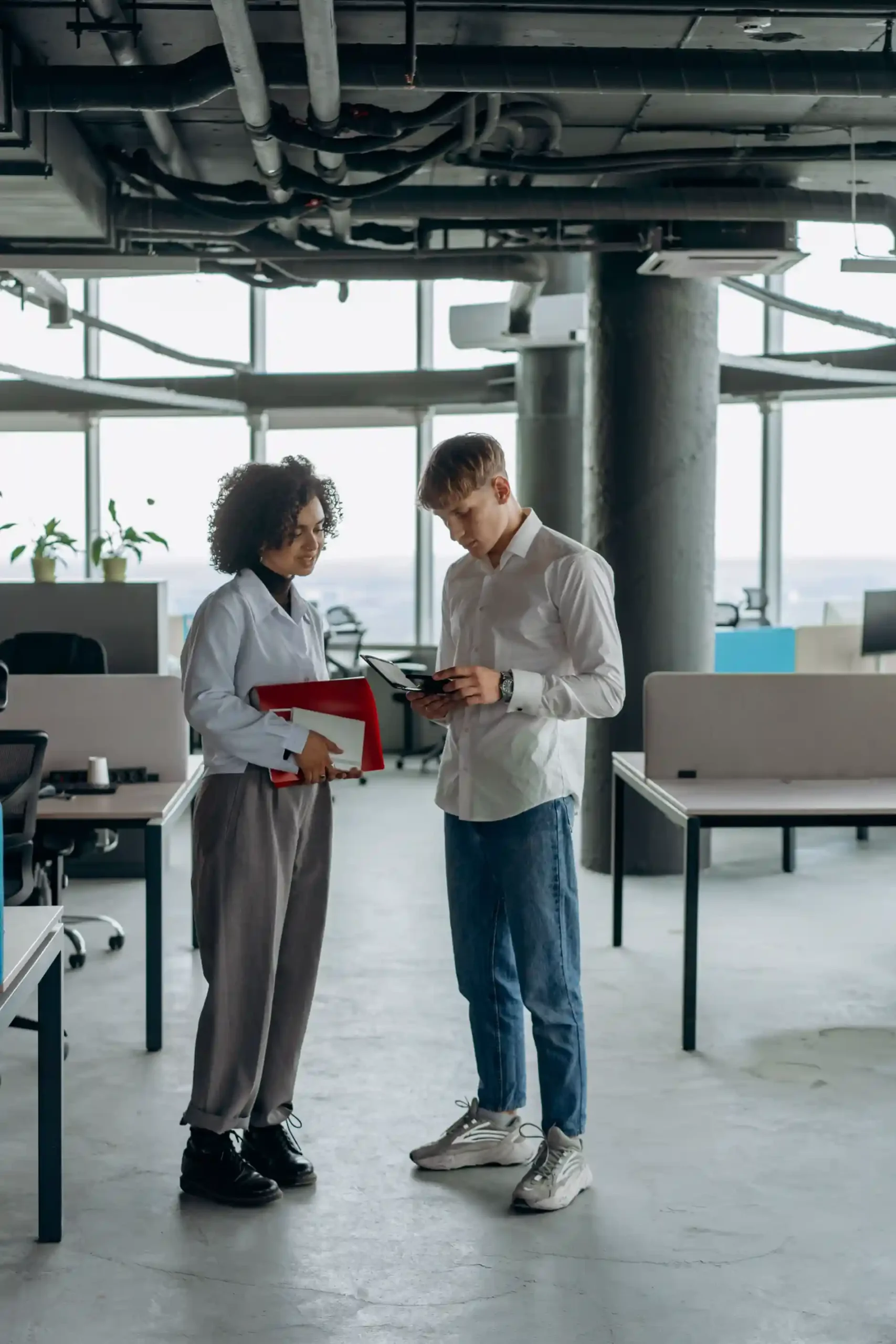 Split image showing a creative agency worker in dark denim and clean sneakers next to a finance professional in tailored dress pants and loafers.