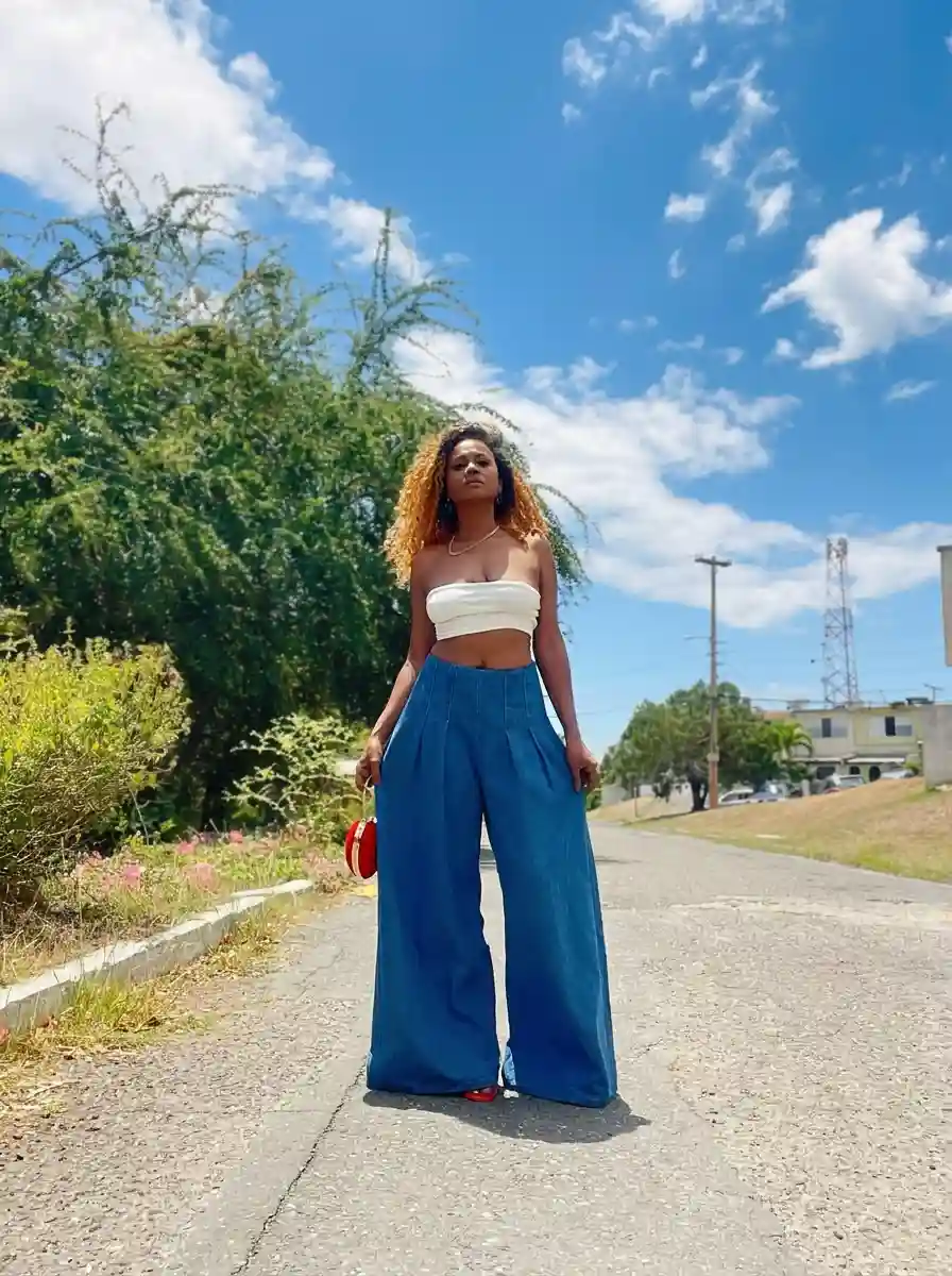 Woman in high-rise wide-leg jeans and a fitted crop top on a summer street