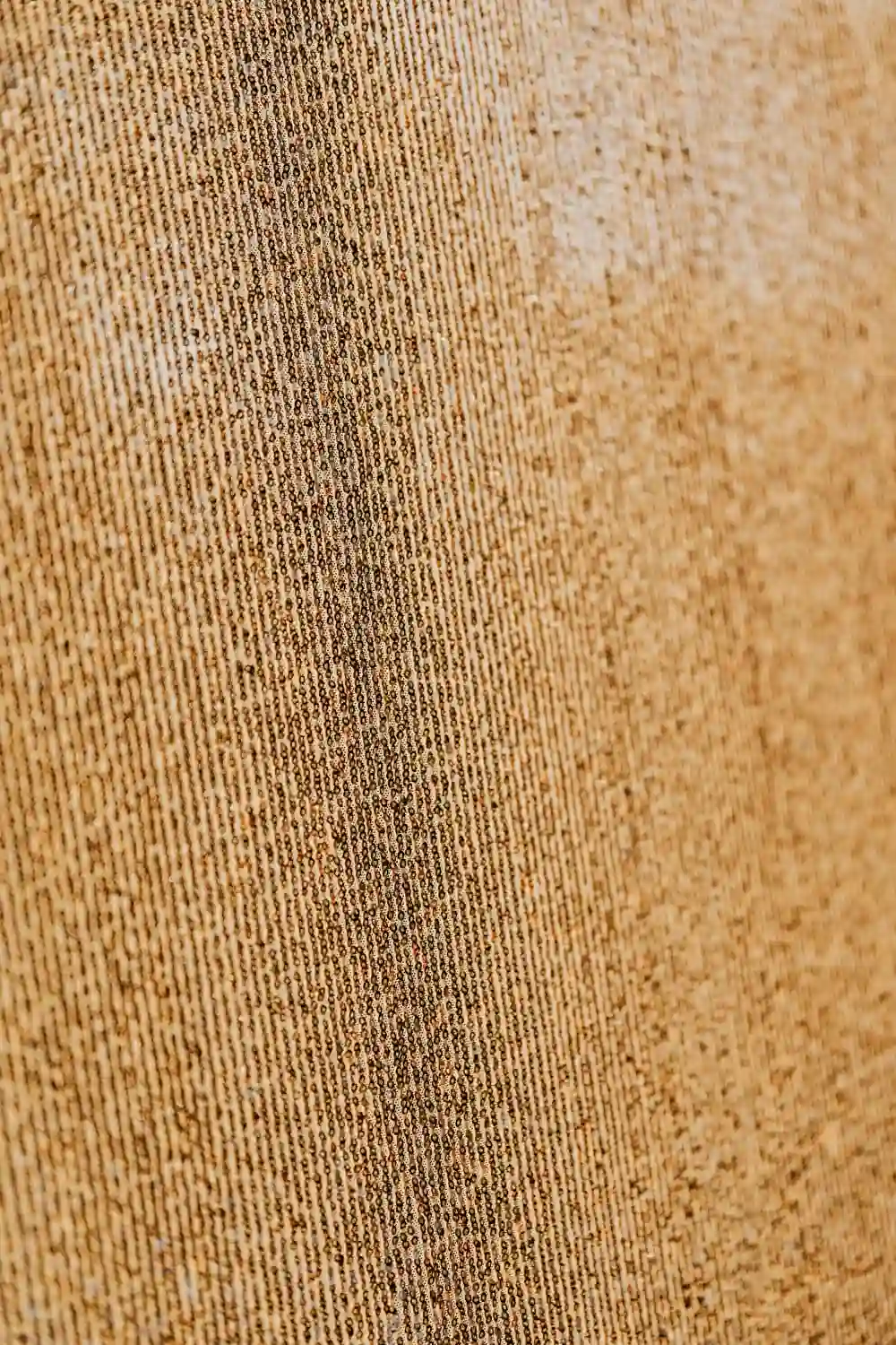 Close-up of a rust brown woven fabric showing visible texture and soft folds